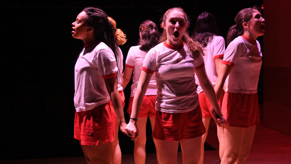 6 young women holding hands in a circle facing outward.