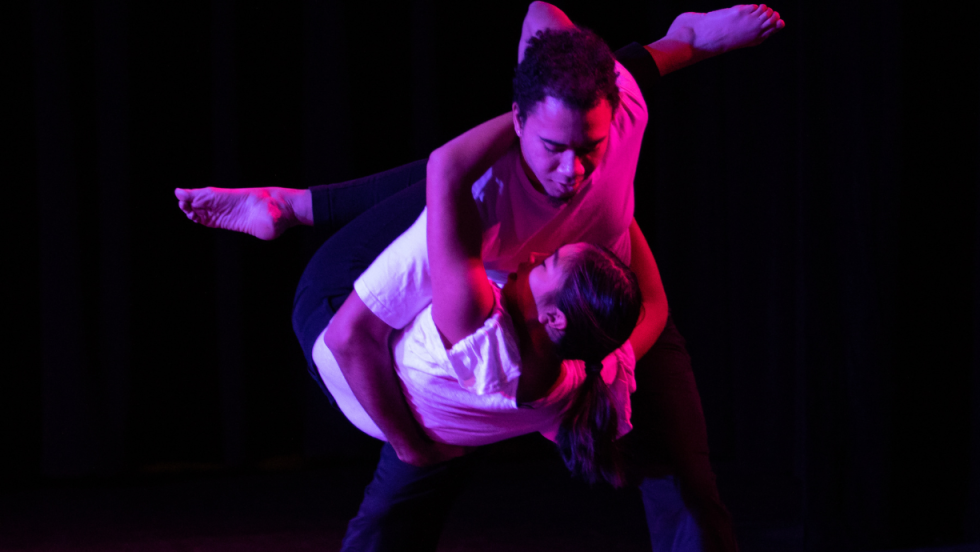 A man and woman dancing in an embrace 