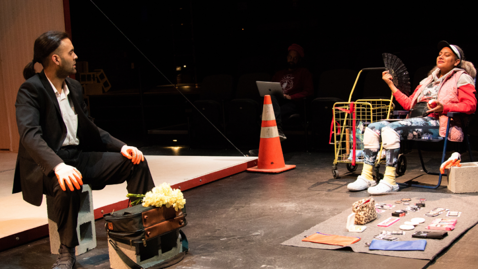 A man sitting in a suit talking to a woman sitting in a lawn chair. 