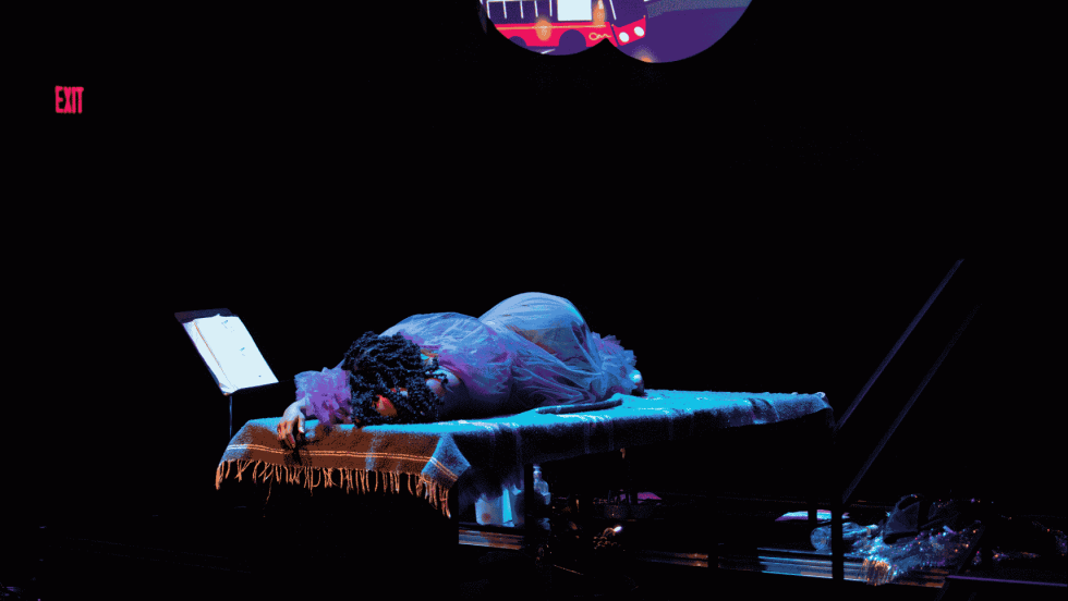 A woman in a purple robe laying face down. 